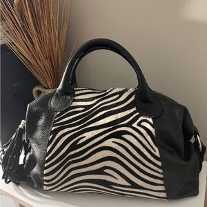 Leather handbag with animal print.